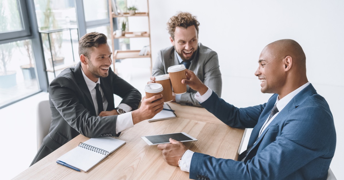 multicultural-group-of-smiling-businessmen-clinking-disposable-cups-picture-id819639878